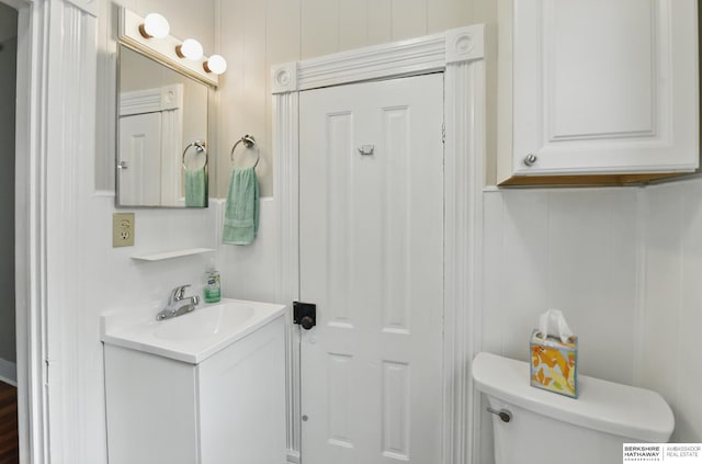bathroom featuring vanity and toilet