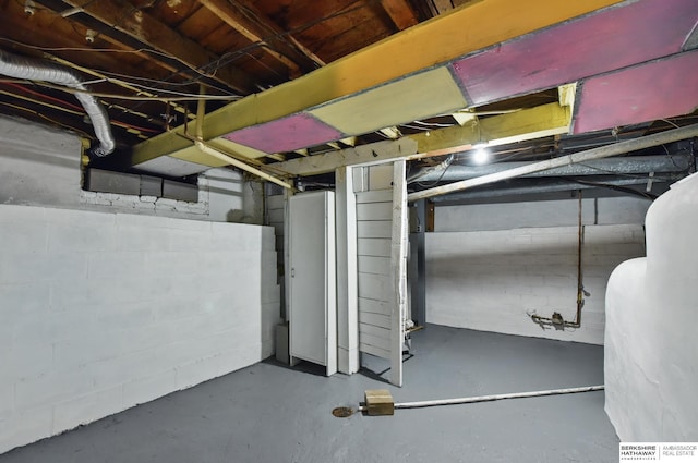 unfinished basement with oil tank