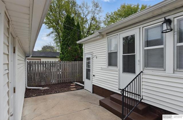 view of patio featuring entry steps and fence