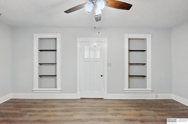 foyer entrance featuring wood finished floors, ceiling fan, and baseboards