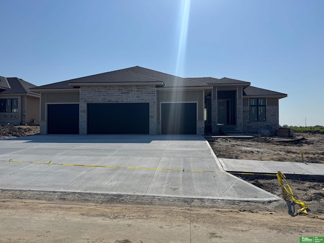 5705 N 197th St, Elkhorn, NE 68022 - prairie-style home featuring an attached garage, concrete driveway, and brick siding