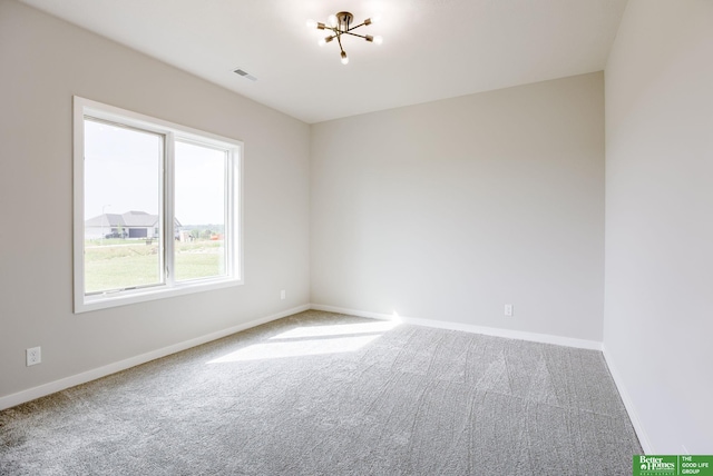 5705 N 197th St, Elkhorn, NE 68022 - carpeted spare room featuring baseboards and a chandelier