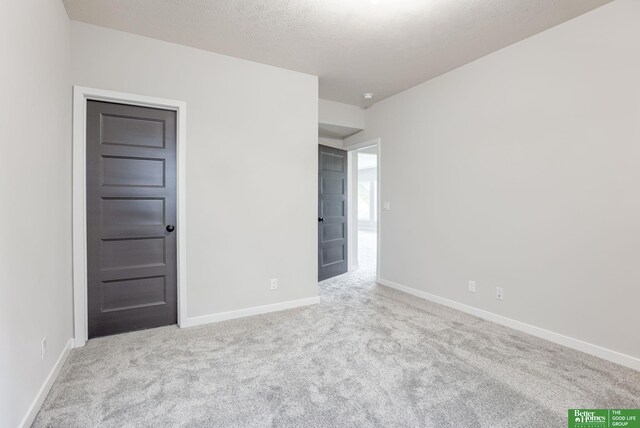 5705 N 197th St, Elkhorn, NE 68022 - empty room with carpet and a textured ceiling