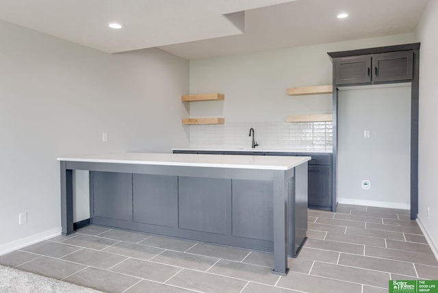 5705 N 197th St, Elkhorn, NE 68022 - kitchen with open shelves, light countertops, a peninsula, decorative backsplash, and recessed lighting