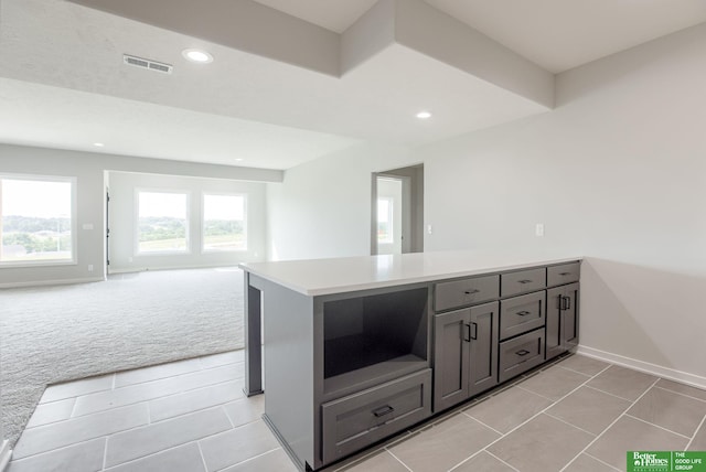 5705 N 197th St, Elkhorn, NE 68022 - kitchen with light tile patterned flooring, light countertops, recessed lighting, open floor plan, and light colored carpet
