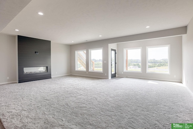 5705 N 197th St, Elkhorn, NE 68022 - unfurnished living room featuring carpet flooring, a fireplace, and recessed lighting