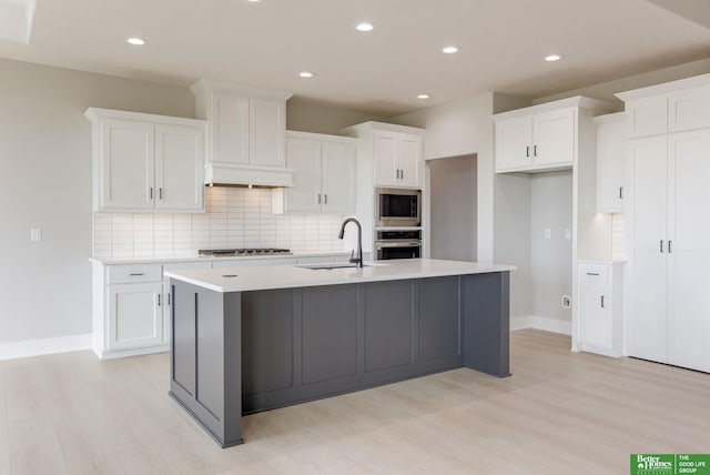 5705 N 197th St, Elkhorn, NE 68022 - kitchen featuring appliances with stainless steel finishes, light wood-style flooring, backsplash, white cabinets, and recessed lighting
