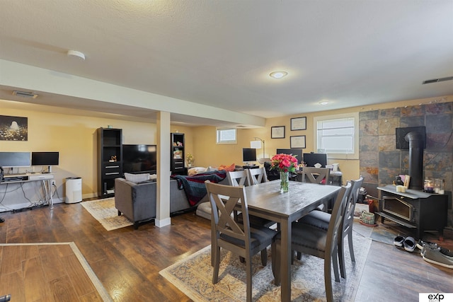 1909 Collins Dr, Bellevue, NE 68005 - dining space featuring a wood stove, healthy amount of natural light, and wood finished floors