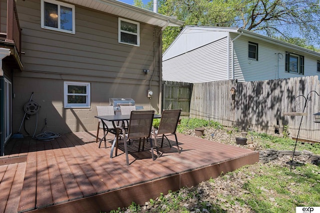 1909 Collins Dr, Bellevue, NE 68005 - wooden terrace with fence, outdoor dining area, and a grill