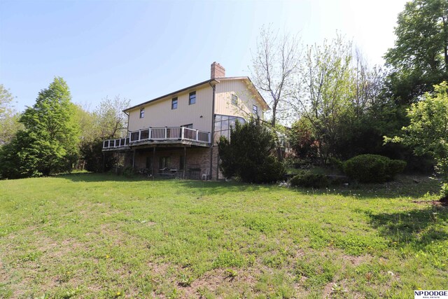 view of grassy yard featuring a wooden deck