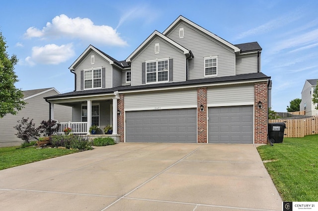 2421 Sand Hills Dr, Papillion, NE 68046 - traditional home with covered porch, brick siding, an attached garage, and driveway