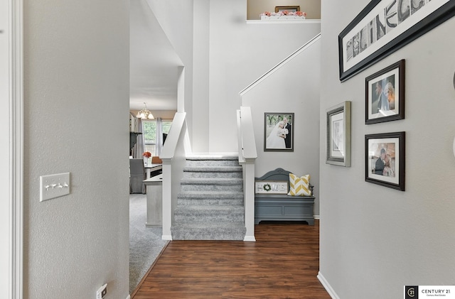 2421 Sand Hills Dr, Papillion, NE 68046 - hall with a chandelier, wood finished floors, stairway, and baseboards