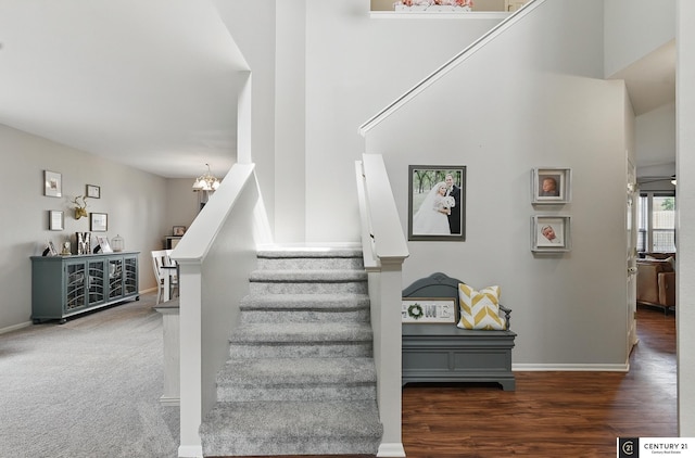 2421 Sand Hills Dr, Papillion, NE 68046 - stairway featuring a chandelier, baseboards, and wood finished floors