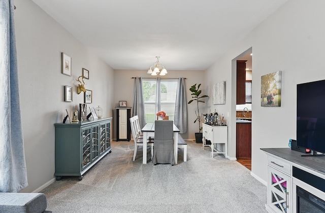 2421 Sand Hills Dr, Papillion, NE 68046 - carpeted dining space featuring a chandelier, baseboards, and a sink