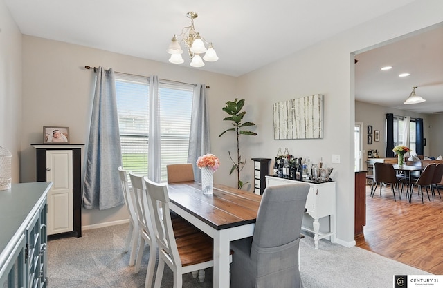 2421 Sand Hills Dr, Papillion, NE 68046 - dining space with a chandelier, plenty of natural light, light carpet, baseboards, and recessed lighting