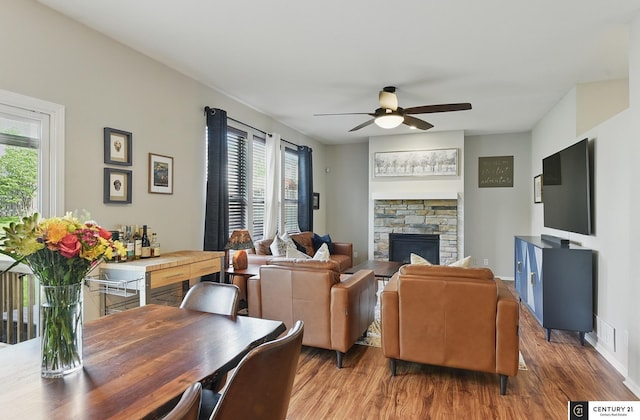 2421 Sand Hills Dr, Papillion, NE 68046 - living room with a ceiling fan, wood finished floors, a fireplace, and baseboards