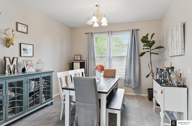 2421 Sand Hills Dr, Papillion, NE 68046 - carpeted dining room with a chandelier and baseboards