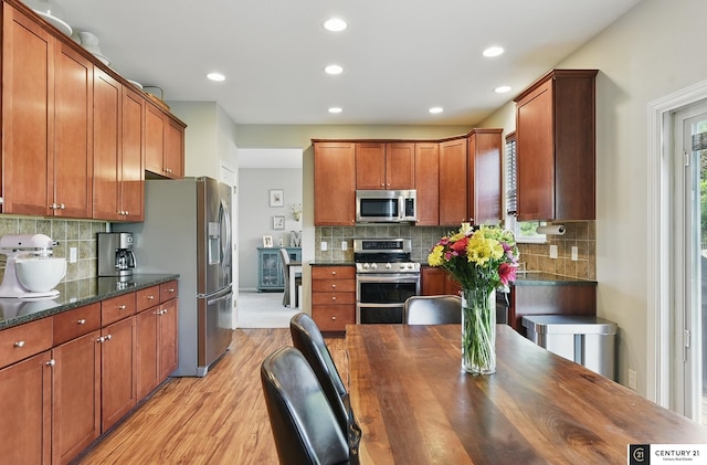 2421 Sand Hills Dr, Papillion, NE 68046 - kitchen featuring stainless steel appliances, light wood-style floors, decorative backsplash, recessed lighting, and brown cabinetry