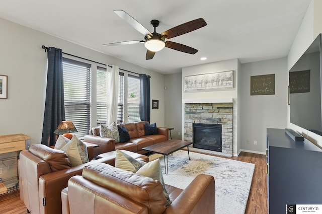 2421 Sand Hills Dr, Papillion, NE 68046 - living room with a ceiling fan, wood finished floors, a stone fireplace, baseboards, and recessed lighting
