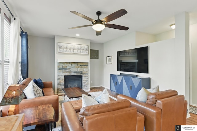 2421 Sand Hills Dr, Papillion, NE 68046 - living room featuring wood finished floors, a ceiling fan, a stone fireplace, baseboards, and recessed lighting