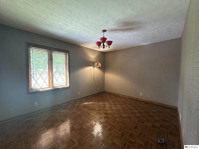 1605 S 113th Plz, Omaha, NE 68144 - unfurnished room with baseboards, a textured ceiling, and a chandelier