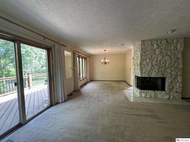 1605 S 113th Plz, Omaha, NE 68144 - unfurnished living room featuring a chandelier, light colored carpet, a textured ceiling, and a stone fireplace