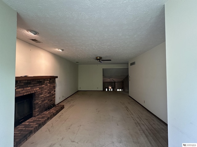1605 S 113th Plz, Omaha, NE 68144 - unfurnished living room featuring ceiling fan, a brick fireplace, and a textured ceiling