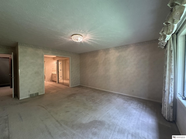 1605 S 113th Plz, Omaha, NE 68144 - carpeted empty room featuring a textured ceiling