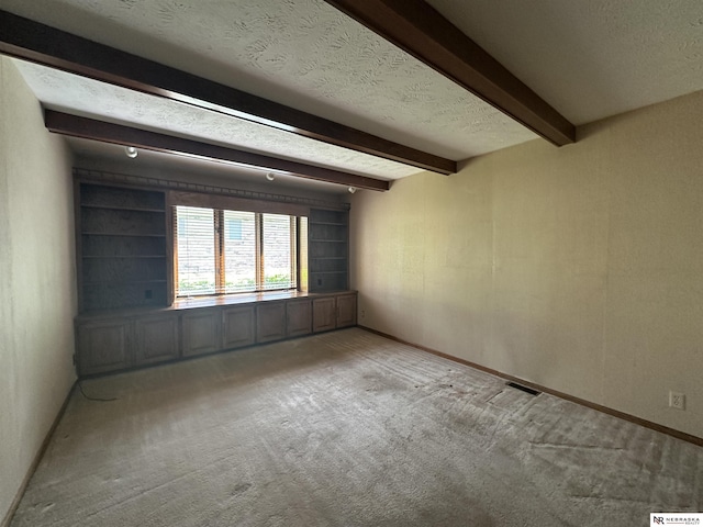 1605 S 113th Plz, Omaha, NE 68144 - carpeted spare room featuring beam ceiling, baseboards, and a textured ceiling