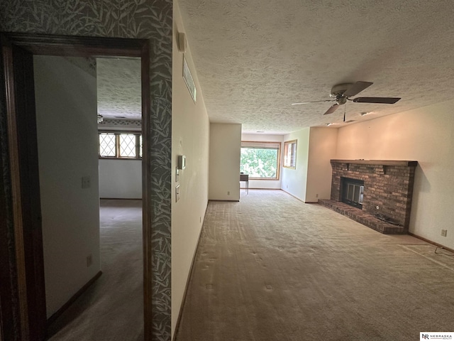 1605 S 113th Plz, Omaha, NE 68144 - unfurnished living room with carpet, ceiling fan, a fireplace, and a textured ceiling