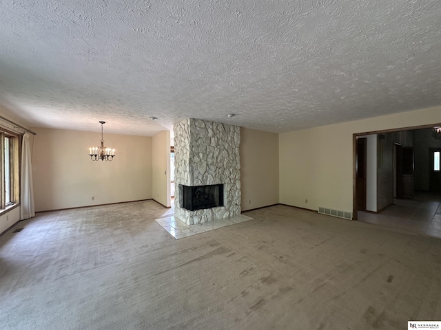 1605 S 113th Plz, Omaha, NE 68144 - unfurnished living room featuring a chandelier, a textured ceiling, a fireplace, light carpet, and baseboards