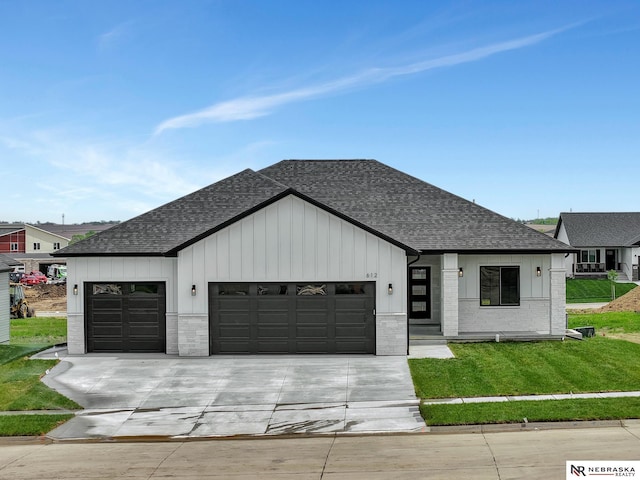 612 N 107th St, Lincoln, NE 68527 - modern farmhouse featuring a shingled roof, a garage, driveway, and a front lawn