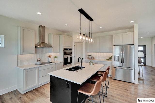 612 N 107th St, Lincoln, NE 68527 - kitchen featuring appliances with stainless steel finishes, wall chimney exhaust hood, a sink, tasteful backsplash, and recessed lighting