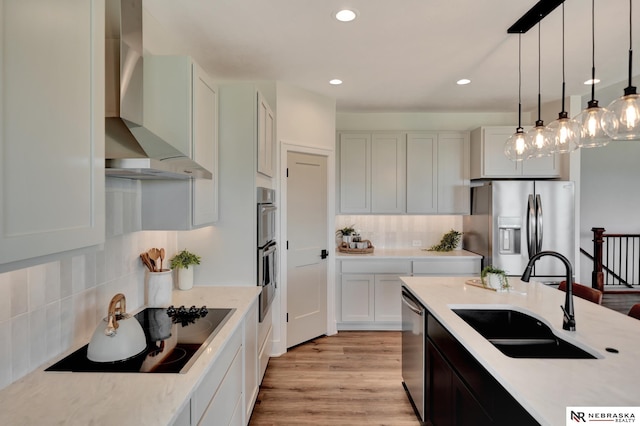 612 N 107th St, Lincoln, NE 68527 - kitchen with wall chimney exhaust hood, stainless steel appliances, a sink, tasteful backsplash, and recessed lighting