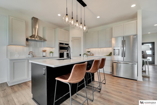 612 N 107th St, Lincoln, NE 68527 - kitchen with stainless steel appliances, wall chimney range hood, light countertops, decorative backsplash, and recessed lighting