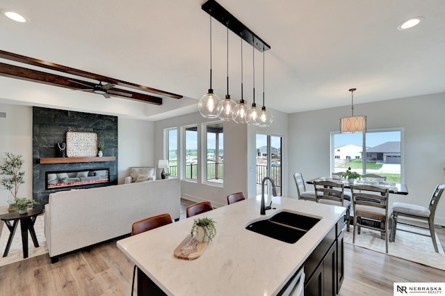 612 N 107th St, Lincoln, NE 68527 - kitchen featuring a sink, light wood-style floors, light countertops, decorative light fixtures, and recessed lighting