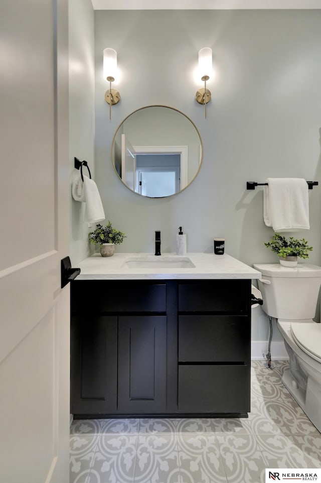 612 N 107th St, Lincoln, NE 68527 - bathroom featuring toilet, vanity, tile patterned floors, and baseboards