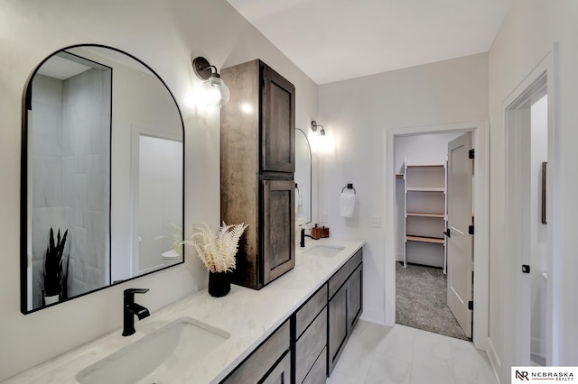 612 N 107th St, Lincoln, NE 68527 - full bath with double vanity, a spacious closet, and baseboards
