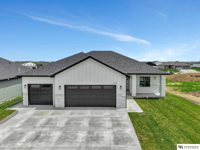 612 N 107th St, Lincoln, NE 68527 - modern farmhouse style home featuring a shingled roof, an attached garage, driveway, a front yard, and board and batten siding