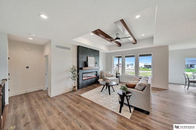 612 N 107th St, Lincoln, NE 68527 - living area with a ceiling fan, a fireplace, light wood-style floors, recessed lighting, and baseboards