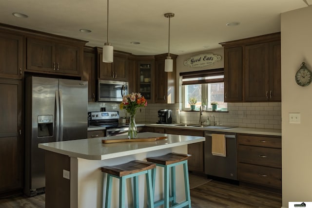 kitchen with stainless steel appliances, dark wood finished floors, tasteful backsplash, and recessed lighting