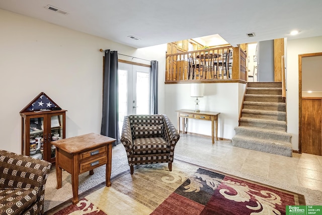 living area featuring stairway and a chandelier