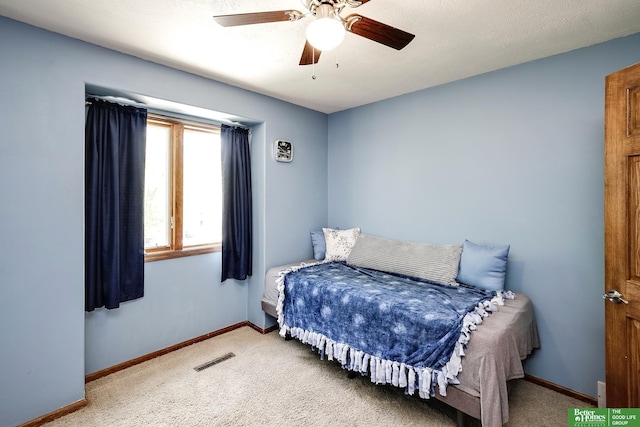 bedroom with carpet flooring, baseboards, and a ceiling fan