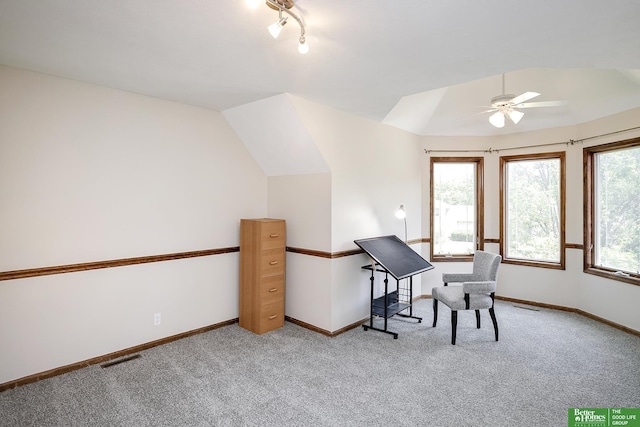 office space featuring light carpet, ceiling fan, baseboards, and lofted ceiling
