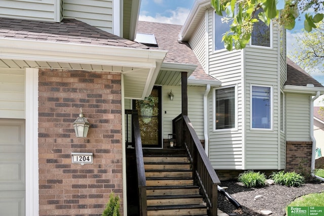 entrance to property with a shingled roof