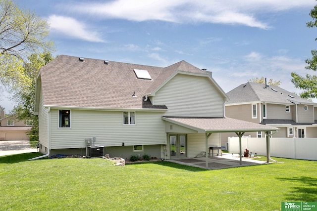 rear view of house with french doors, a patio, roof with shingles, and central AC