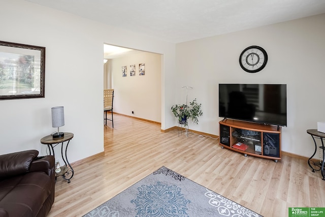 living room with wood finished floors and baseboards