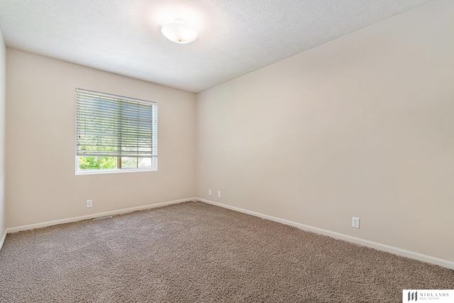 empty room with carpet floors and baseboards