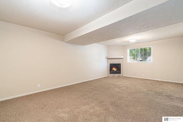 unfurnished living room featuring a fireplace, light colored carpet, and baseboards