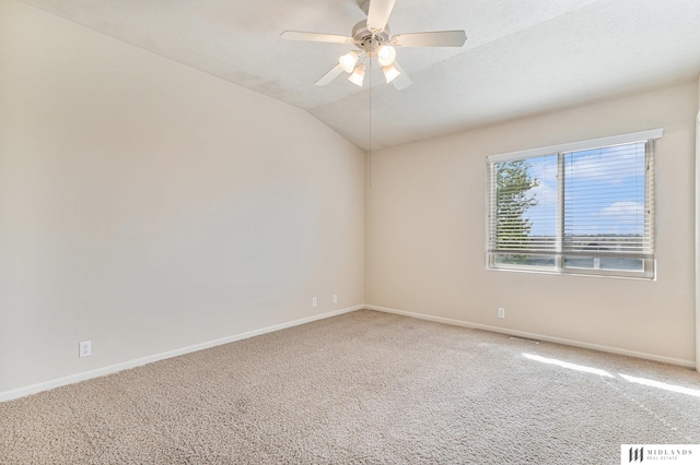 spare room with carpet floors, ceiling fan, baseboards, and lofted ceiling